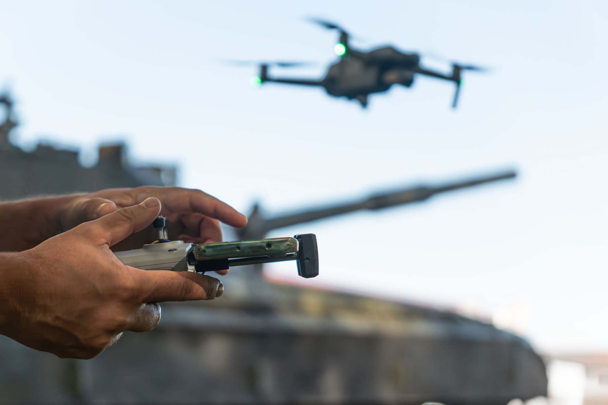 a soldier's hand piloting a drone